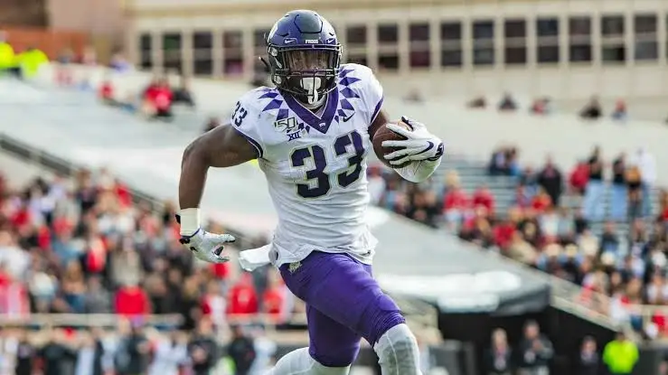 Sewo Olonilua runs with the football for TCU